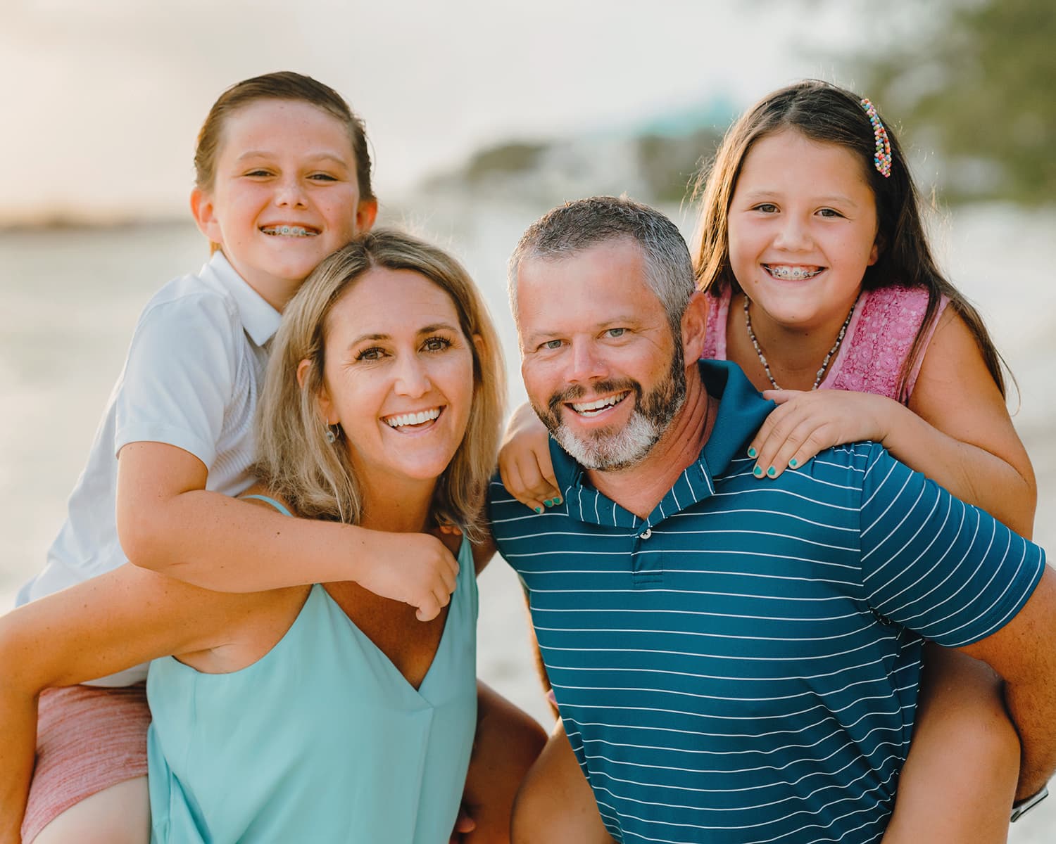 grand cayman islands family photography seven mile beach happy kids piggy back ride