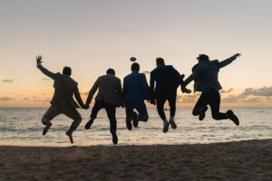 grand cayman kimpton seafire jewish wedding photography groomsmen jump