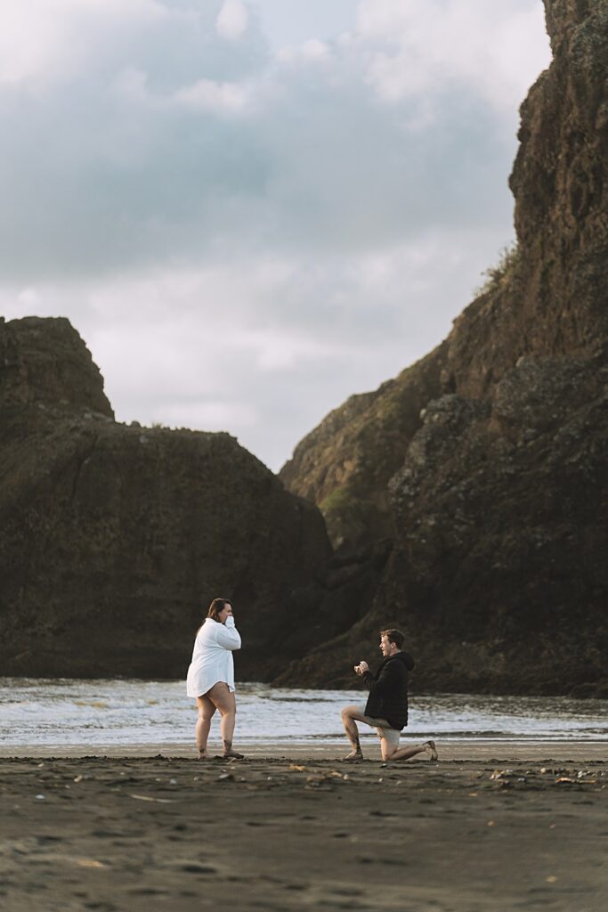 Surprise proposal piha beach auckland engagement photographer