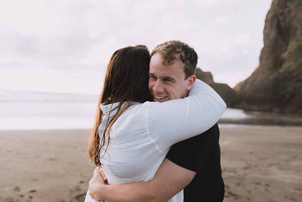 Surprise proposal piha beach auckland engagement photographer