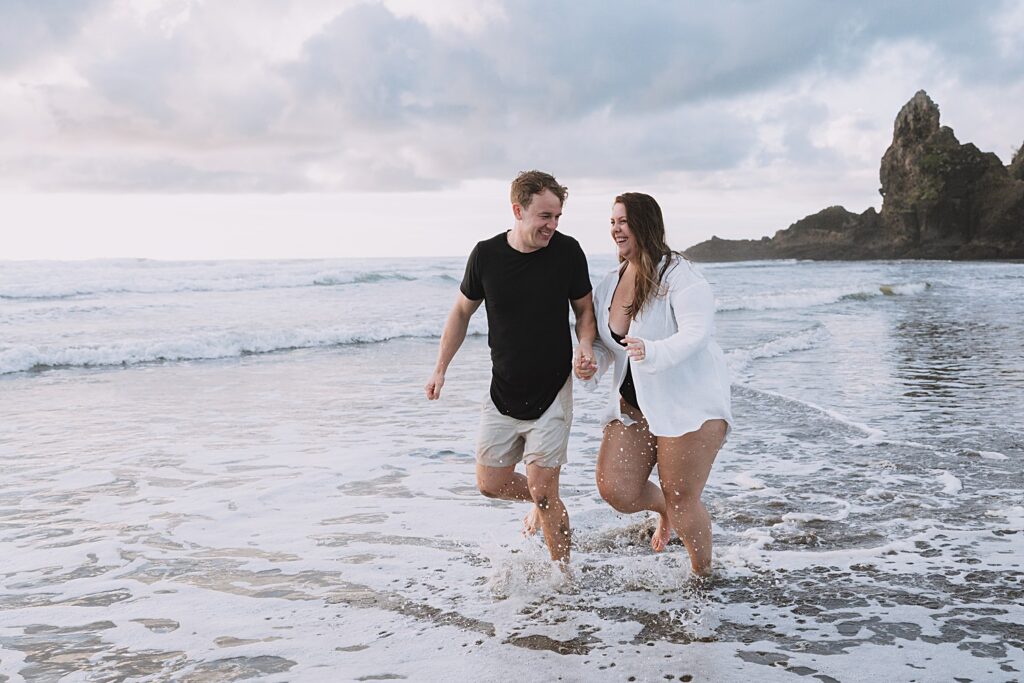 Surprise proposal piha beach auckland engagement photographer